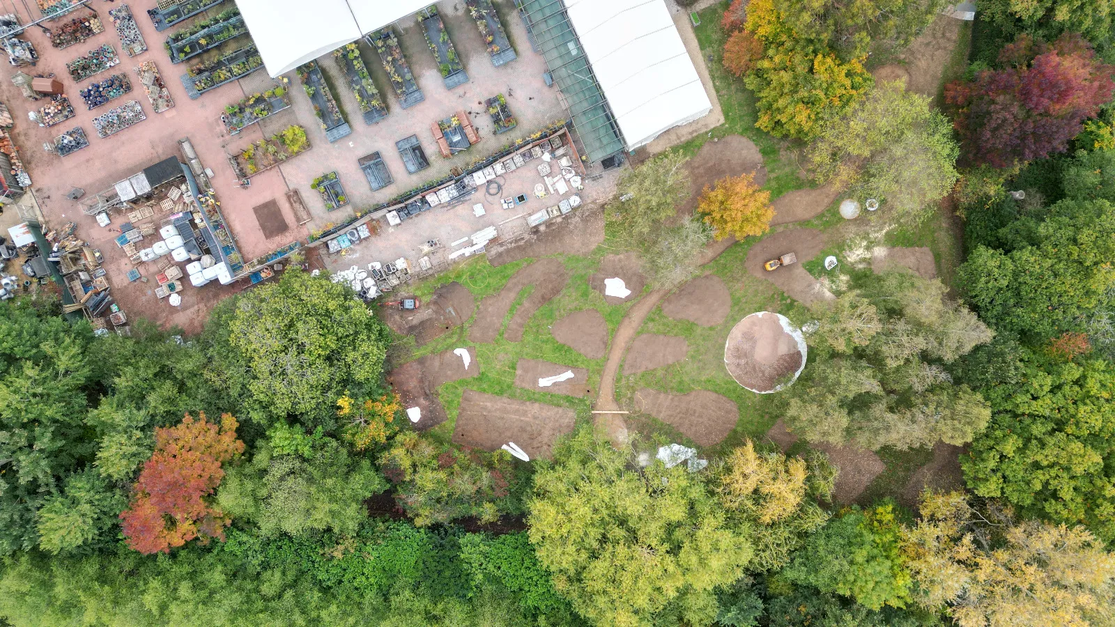 An aerial view of a building surrounded by trees.