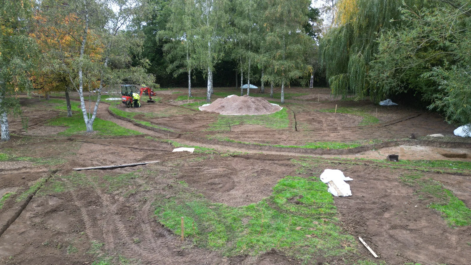 A group of people working in a dirt field.