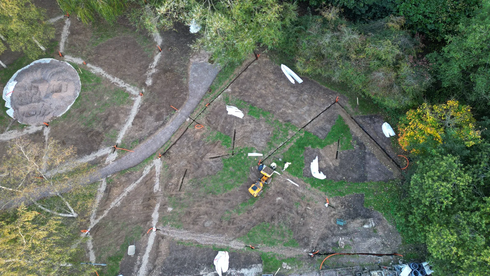An aerial view of a construction site in the woods.