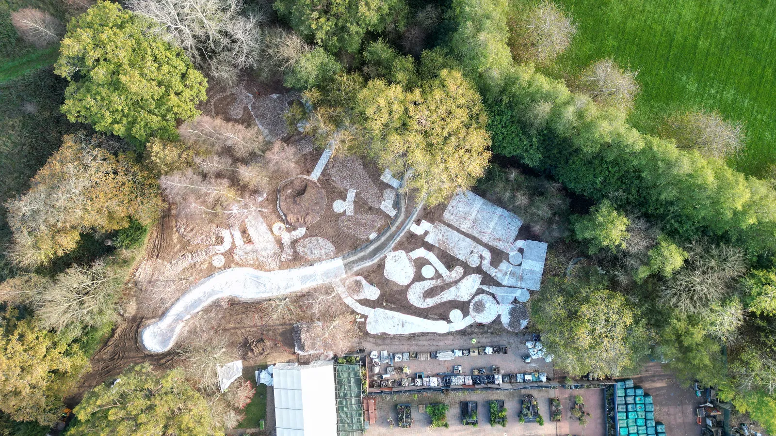 An aerial view of a park in the middle of a forest.