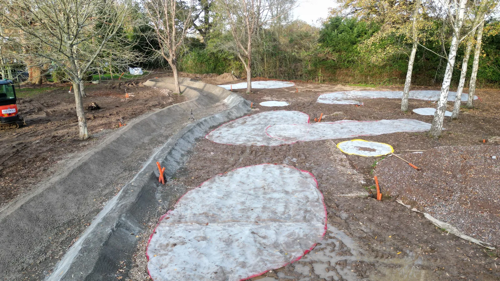 A construction area with a lot of dirt and trees.