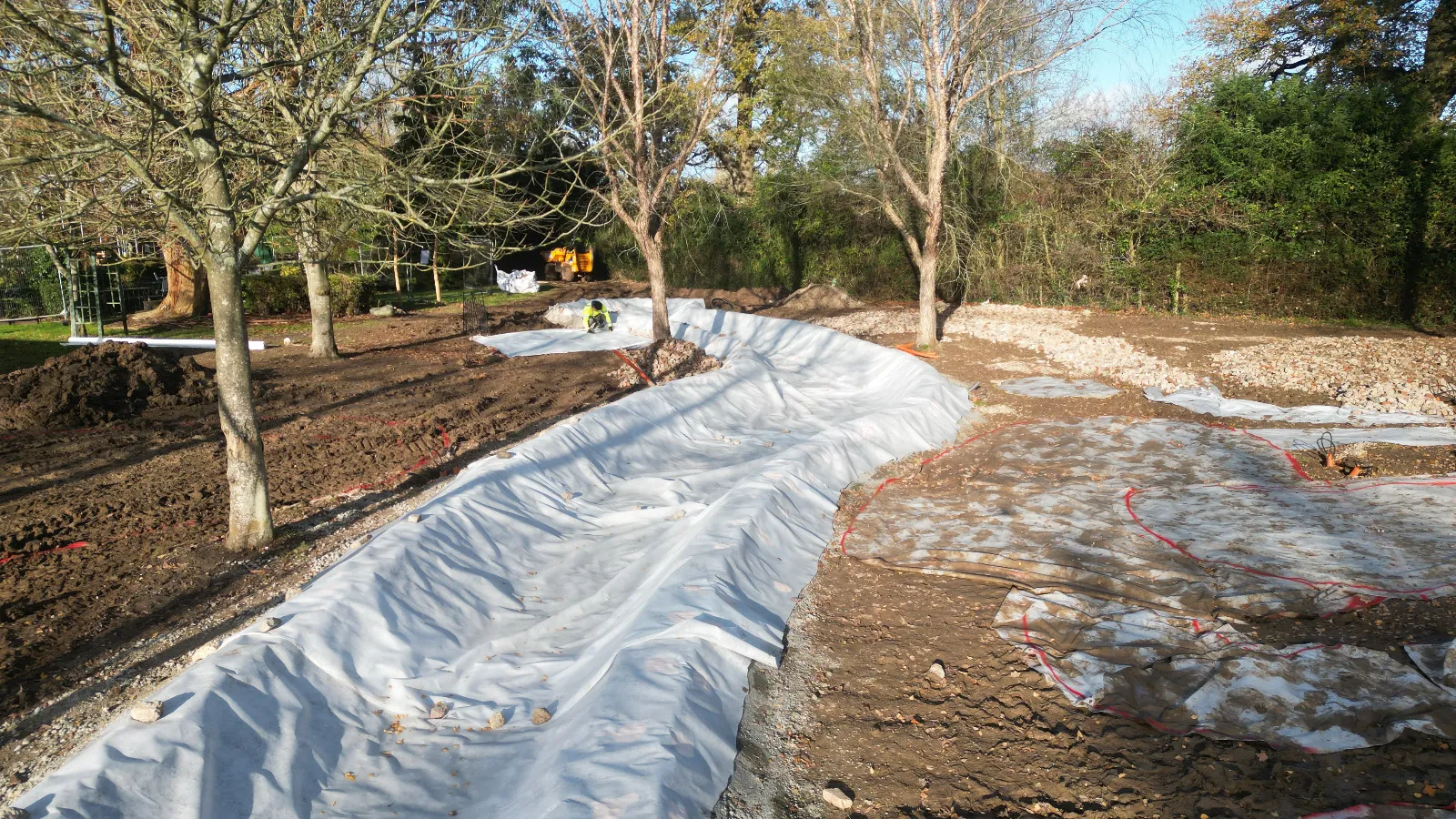 A long snow covered path in the middle of a park.