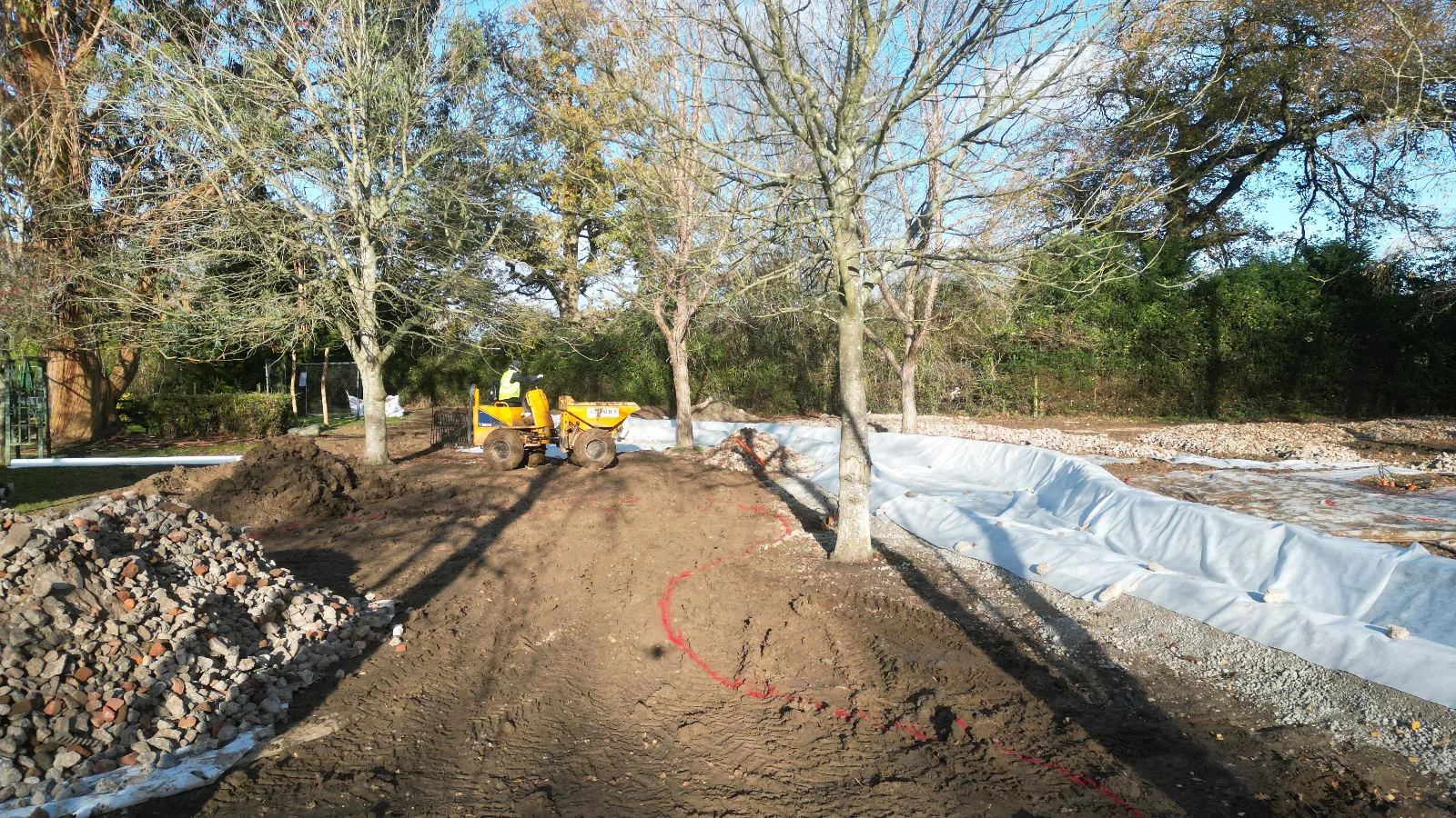 A construction site with a large pile of dirt.